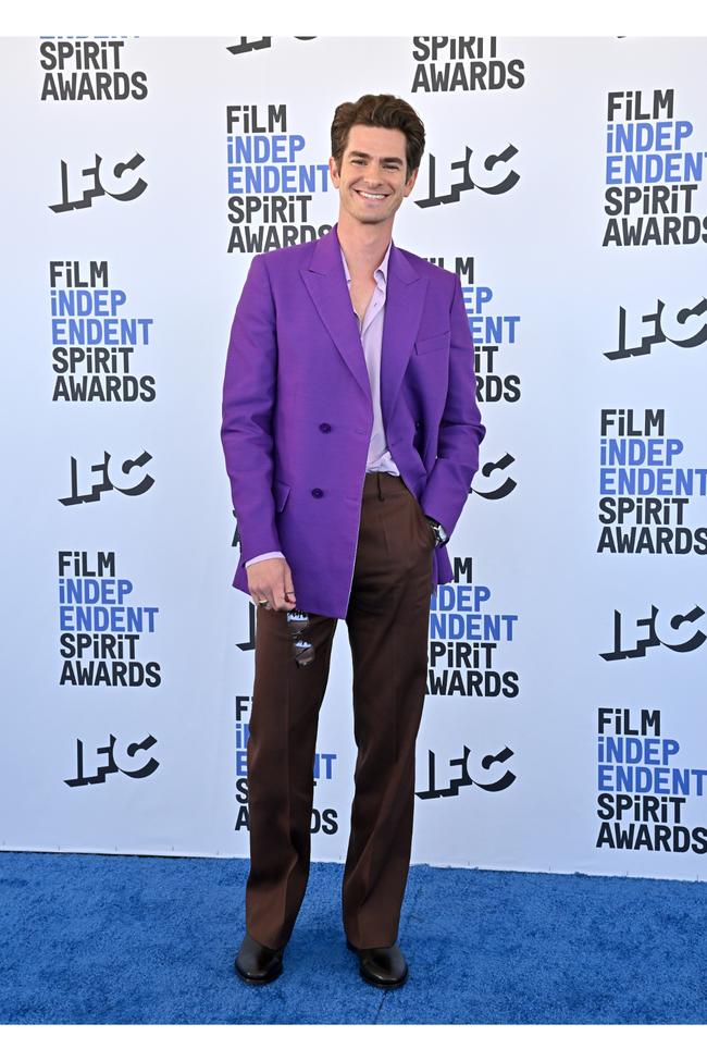 Andrew garfield in purple jacket and brown trousers 