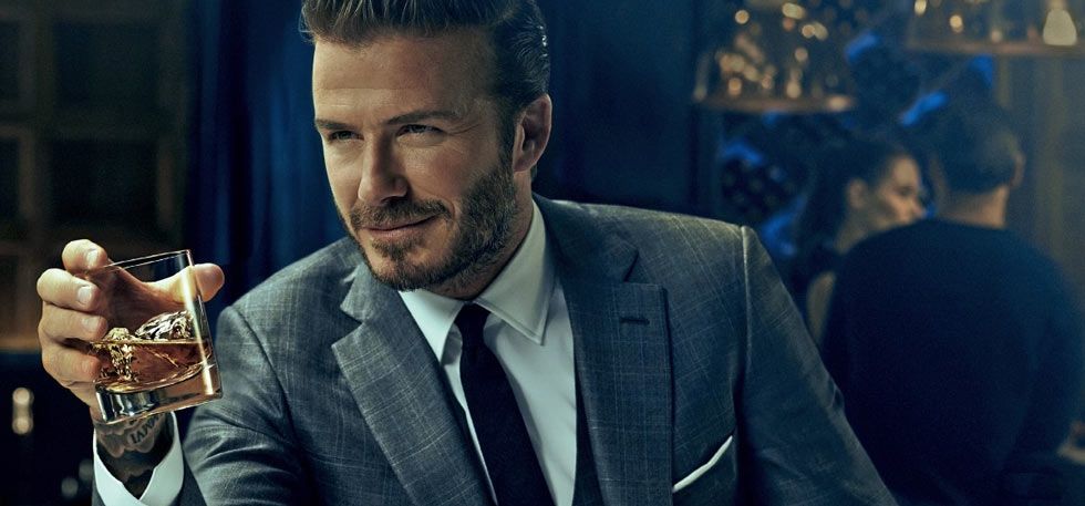 David Beckham holding a whisky glass, showcasing a whisky tasting suit jacket style