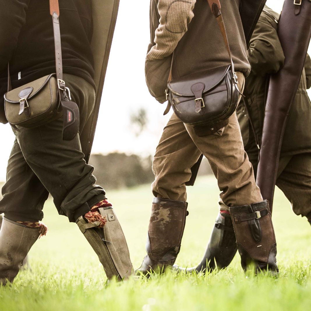 Dark brown wool trousers with pleats, designed for a classic country look.