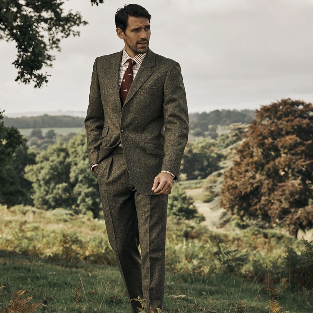 A country-inspired outfit featuring a green tweed suit jacket with contrasting elbow patches.