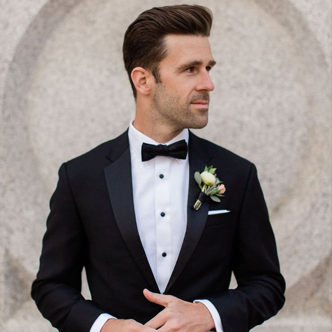 Close-up of a tailored dinner suit with contrasting lapels and a matching pocket square.