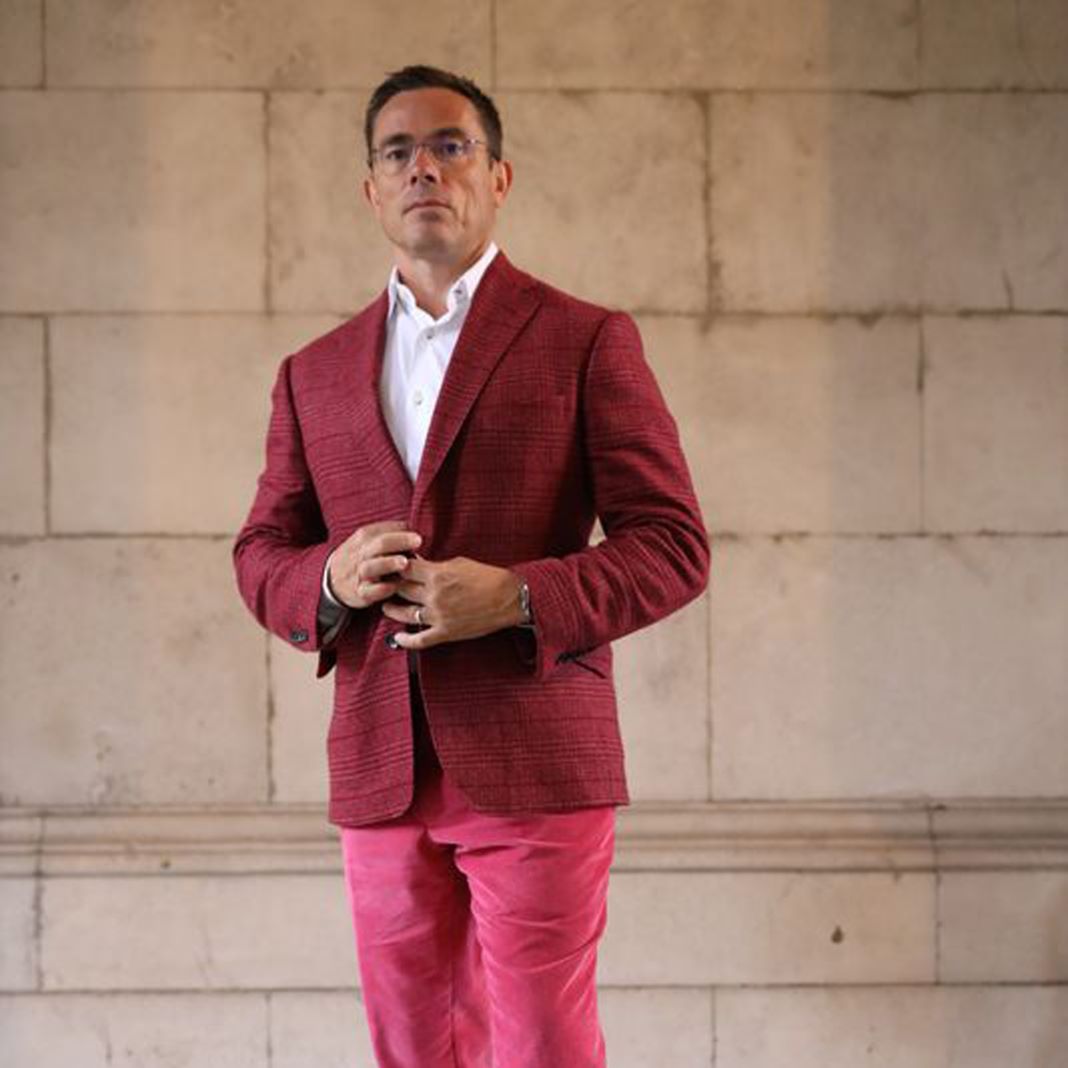 Model showcasing a tailored blazer and trousers in complementary colors.