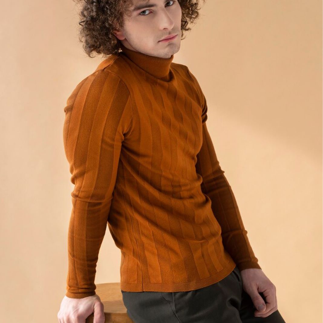 Bold golden brown roll neck sweater with a relaxed fit and subtle textured pattern