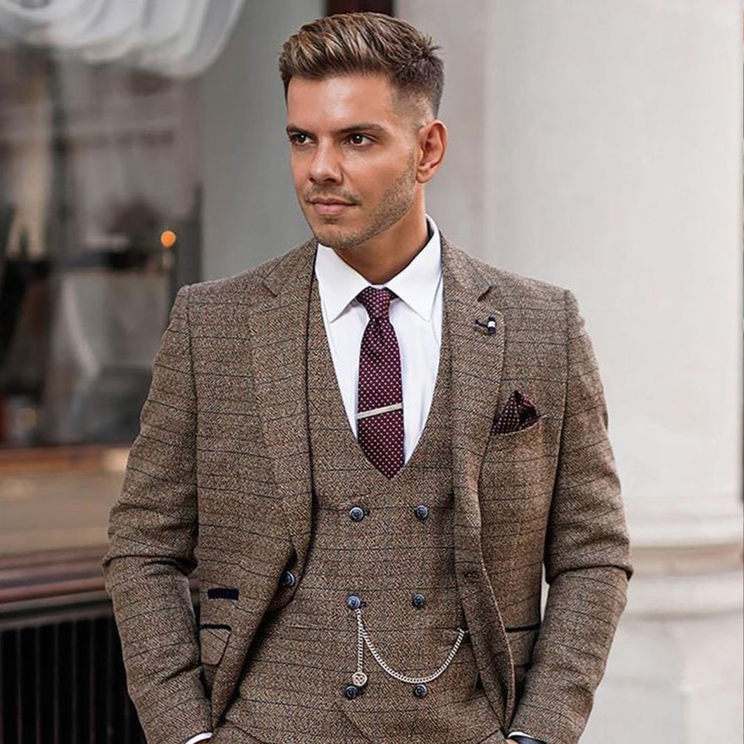 Classic three-piece tweed suit displayed on a model, showcasing its timeless design.