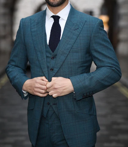 a photo of a man wearing a green roll neck