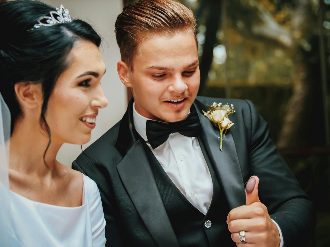 Smiling bride and groom dressed in formal black-tie attire