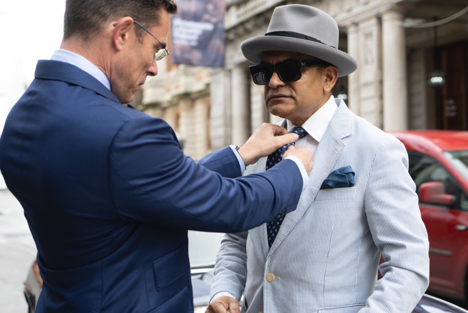 Two men in summer suits showing breathable tailoring and accessory coordination suitable for Hampton Court Garden Festival.</p>
<p>