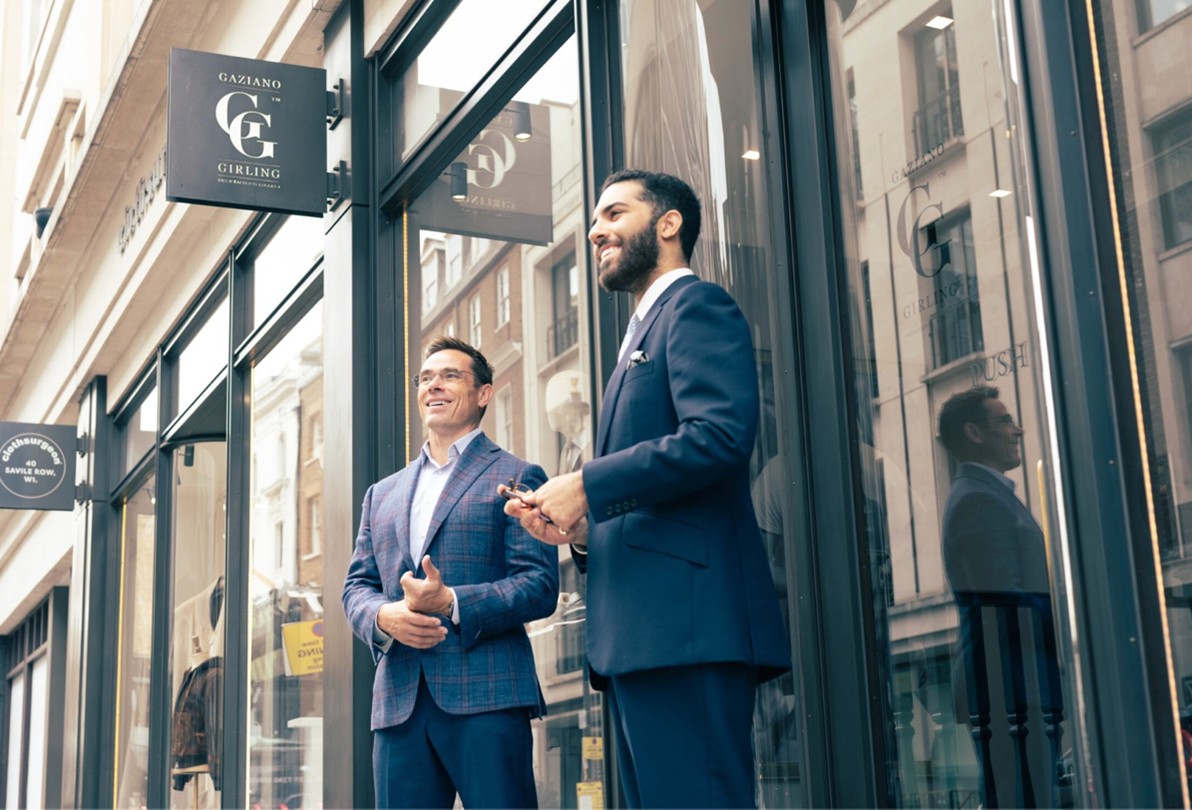A photo of two tailors talking at a Savile Row Celebration