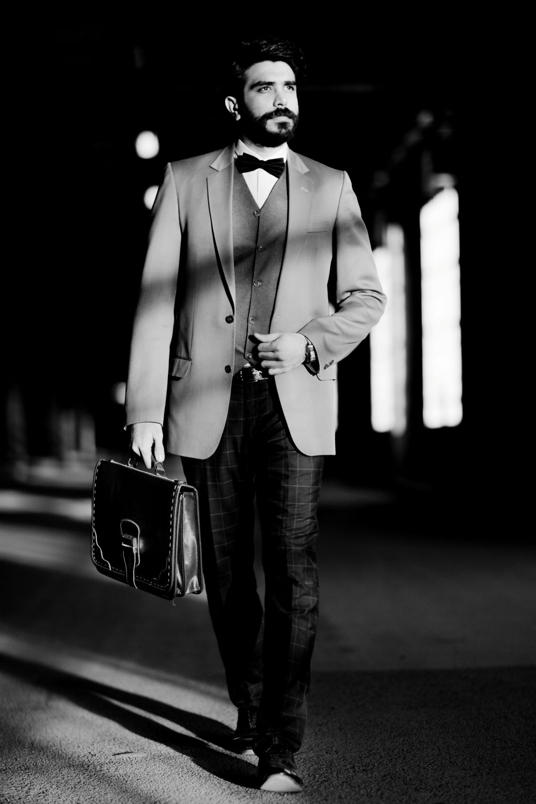 Retro black-and-white aesthetic with tailored suit and briefcase, echoing Jazz Age elegance in everyday city life.