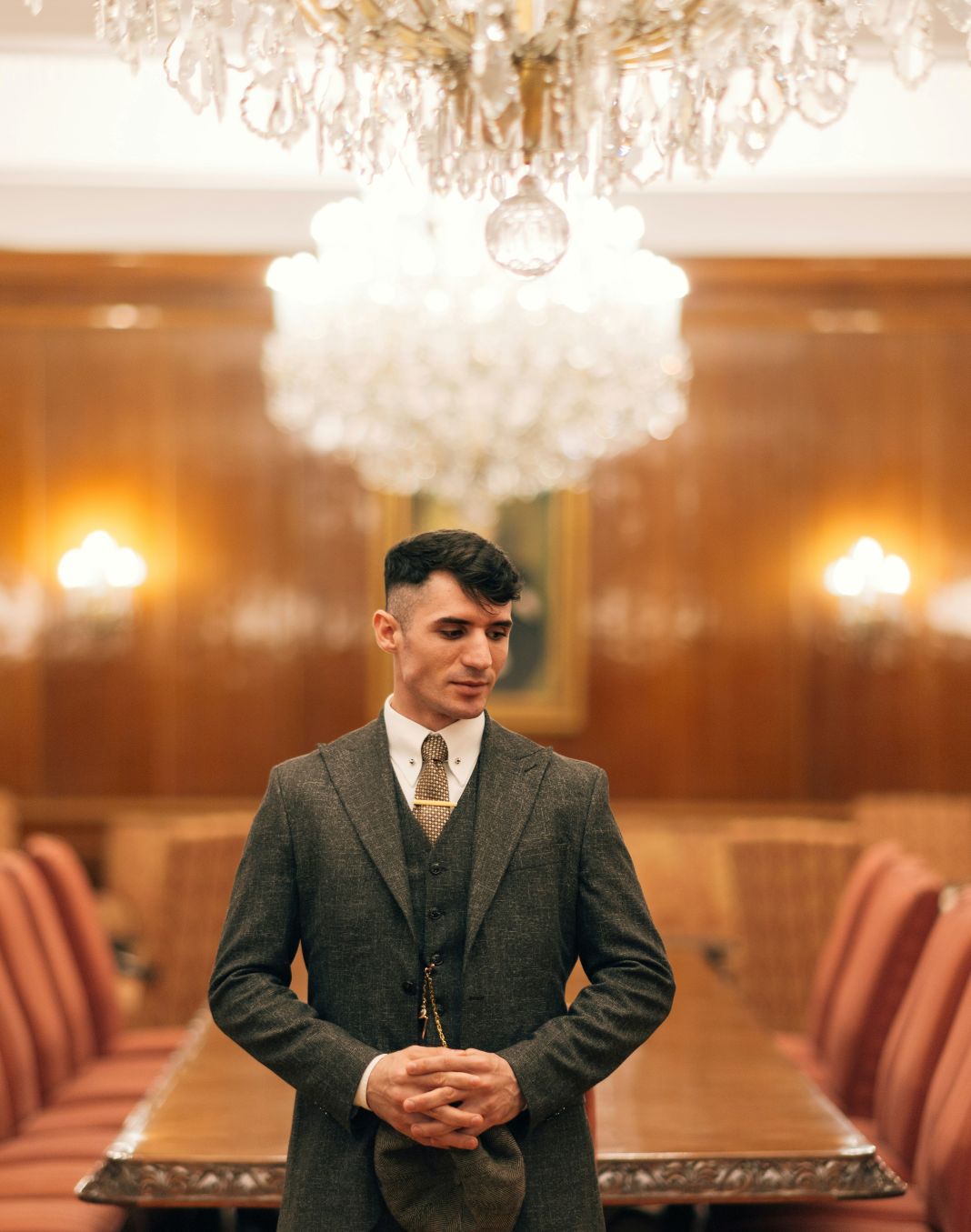 a photo of a man in a sharp three-piece suit that is Gatsby-inspired gentleman exuding 1920s power and sophistication.