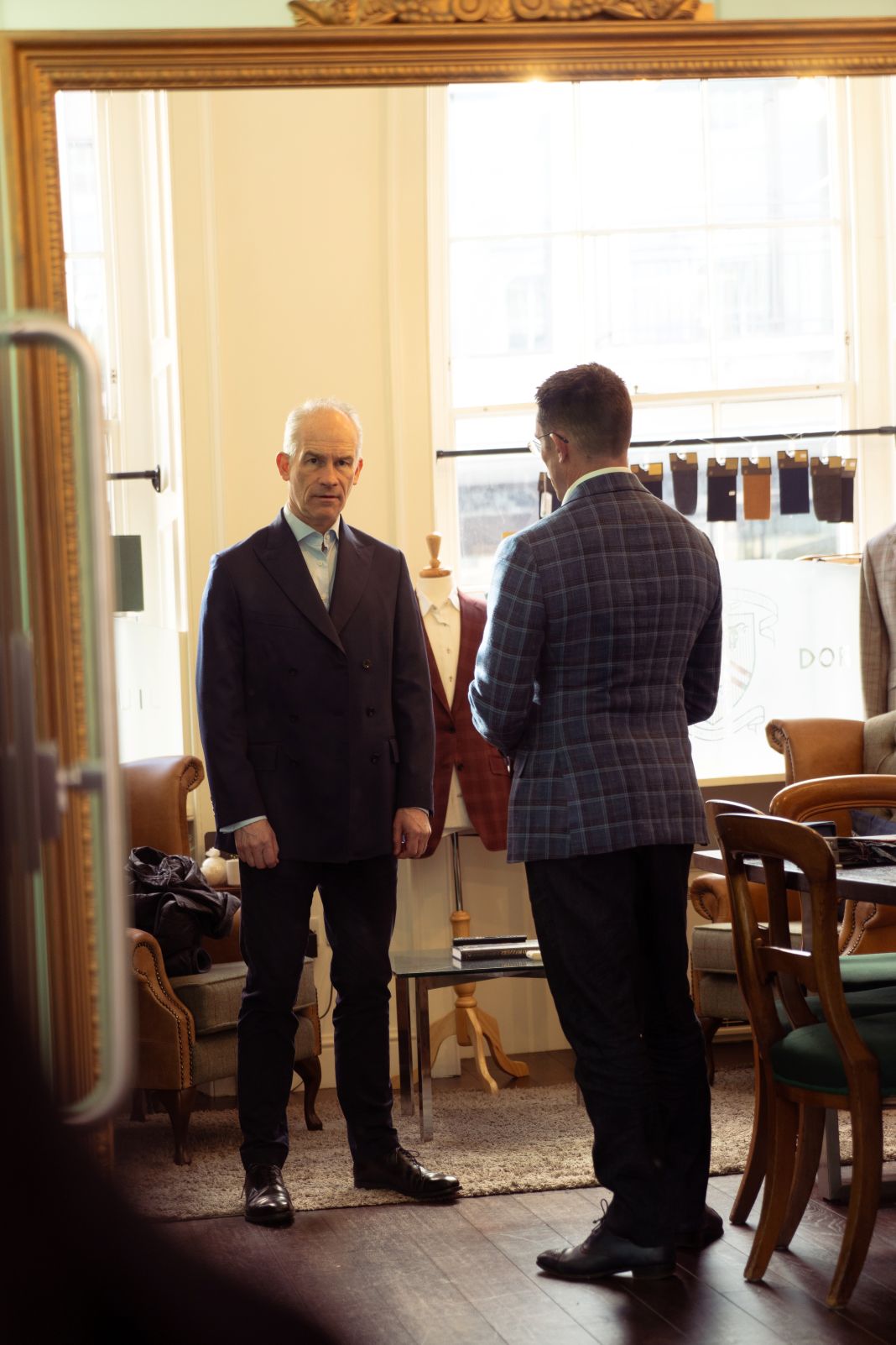 A photo of a gent trying out his jacket for fit A photo of a gent trying out his jacket for fit