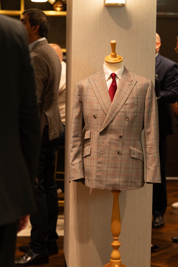 A photo of a tailored jacket on a mannequin at an event