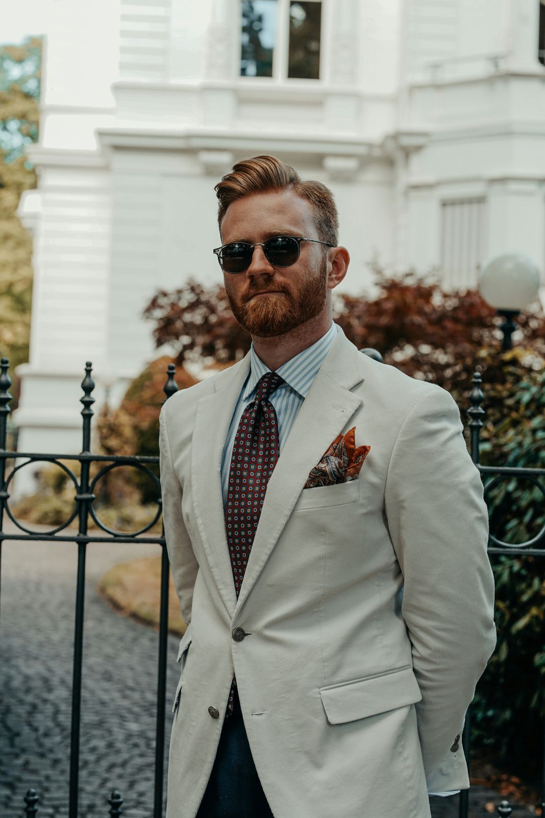 a man dressed in a corduroy suit - unsplash