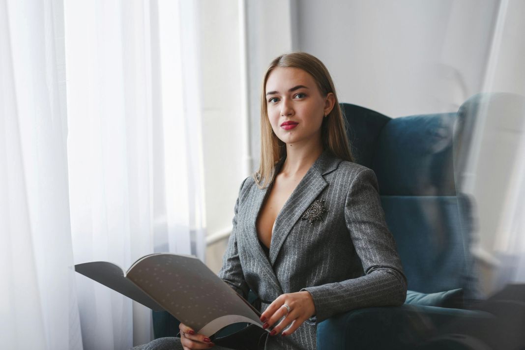 a photo of a business woman seated, reading
