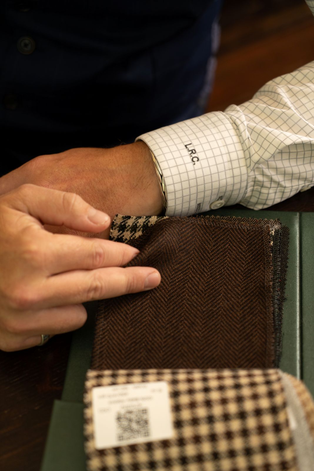 a photo of a tailoring client choosing fabrics
