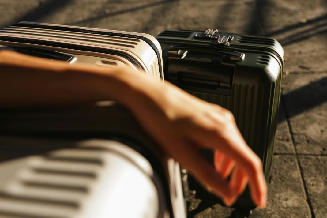 a photo of a traveller with suitcases travelling with a suit