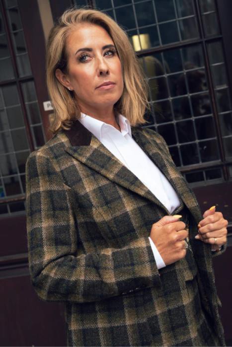 a photo of a woman wearing a three peice suit in tweed for colder weather