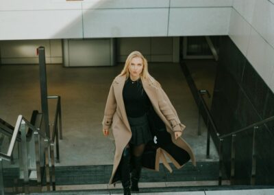 a photo of a woman wearing a wool coat walking up stairs - pexels