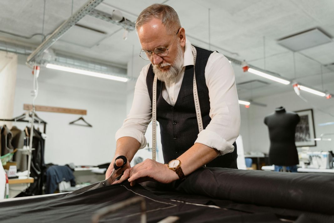 a photo of a tailor at work in a workshop