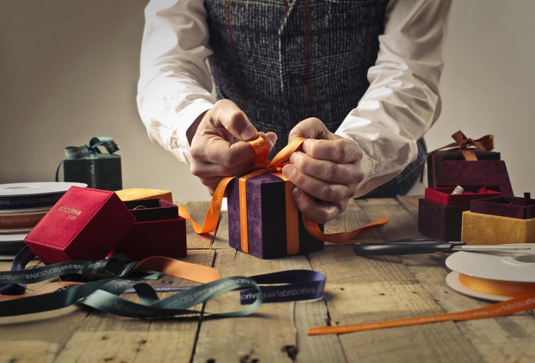 a photo of a tailor wrapping a gift