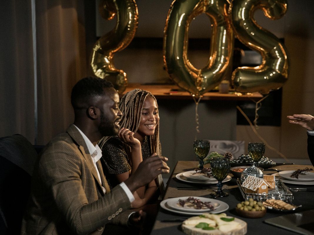 a photo of people enjoying a christmas party feast at a table
