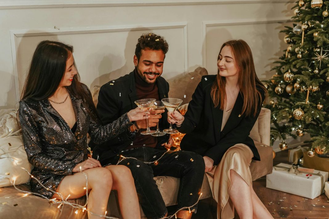 a photo of work colleagues having christmas drinks on a couch