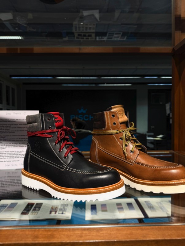 Premium leather boots displayed in a London menswear shop, featuring classic craftsmanship and modern styling