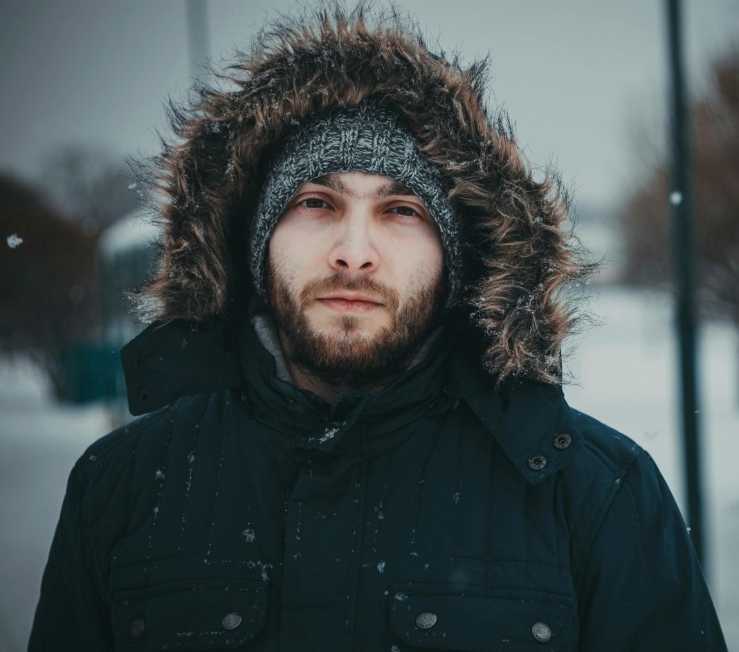 a photo of a man in a parker jacket in the snow