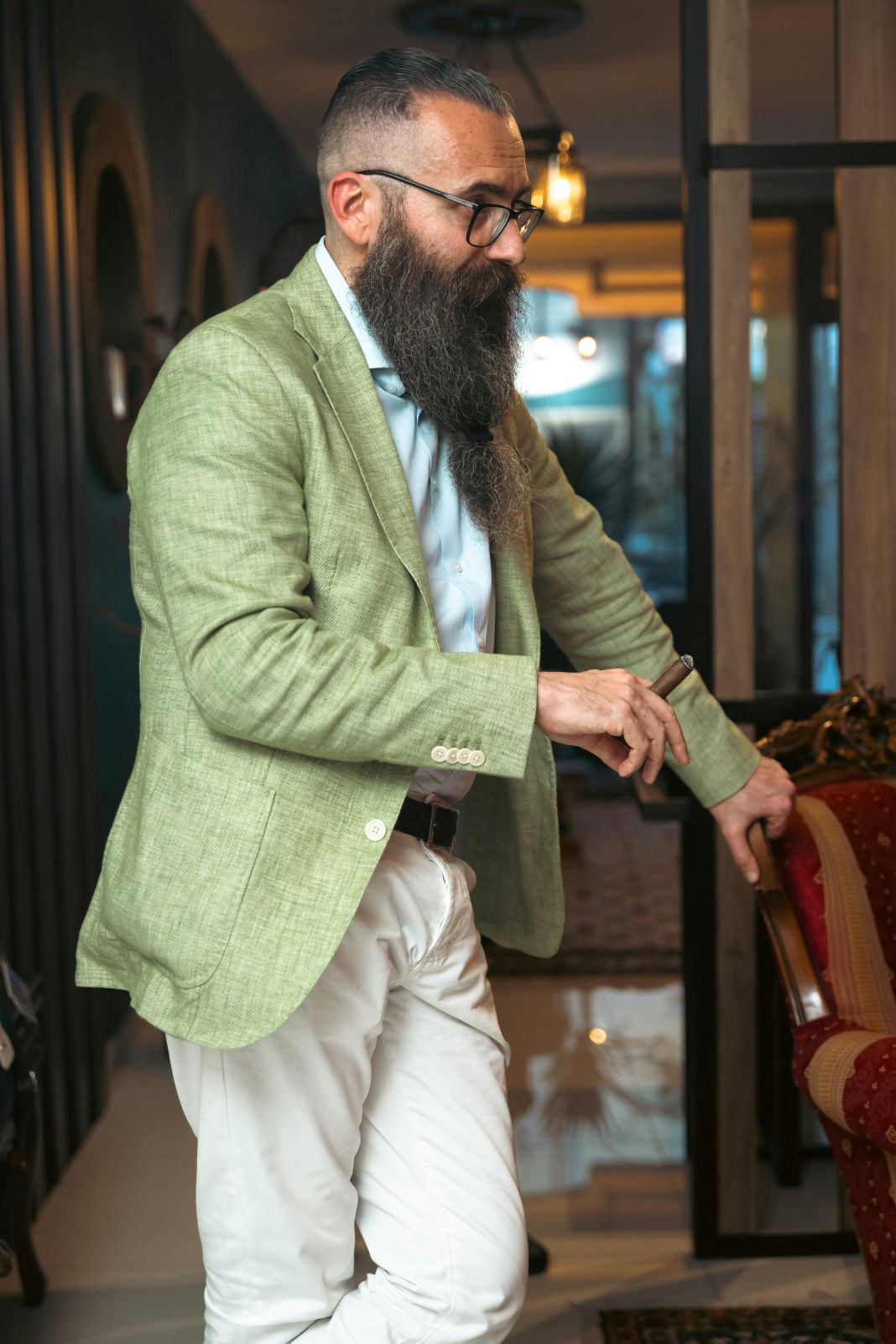 a photo of a man wearing a green blazer