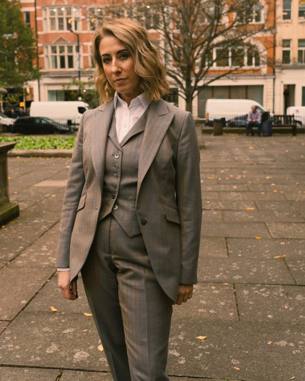 A photo of a trendy woman in london wearing a bespoke suit