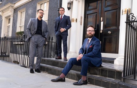 A photo of three tailors wearing skinny suits in London