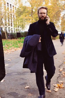 a photo of a tailor dressed 2 kill on the phone