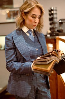 a photo of a tailor looking through materials