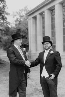 A photo of two men dressed for the races