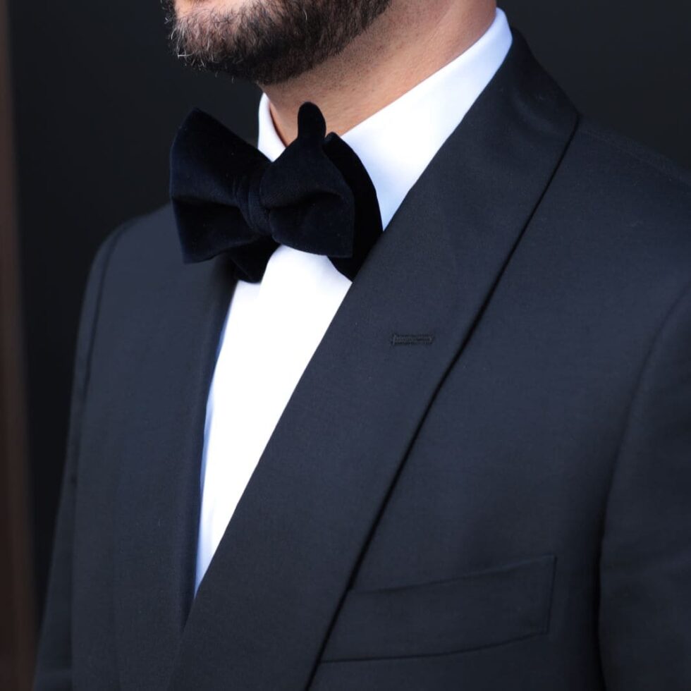 Black bow tie worn with a satin lapel dinner jacket, sample image