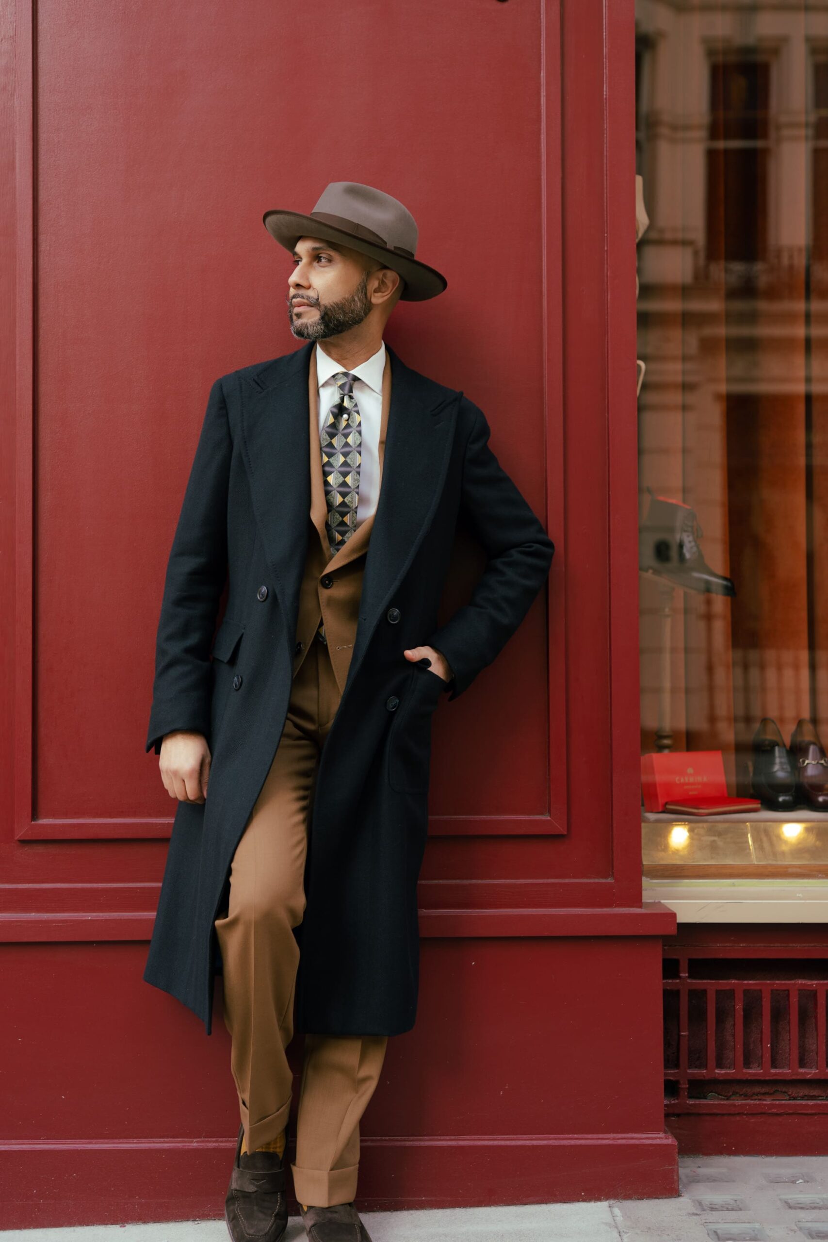 Black tailored overcoat worn over a waistcoat, sample image