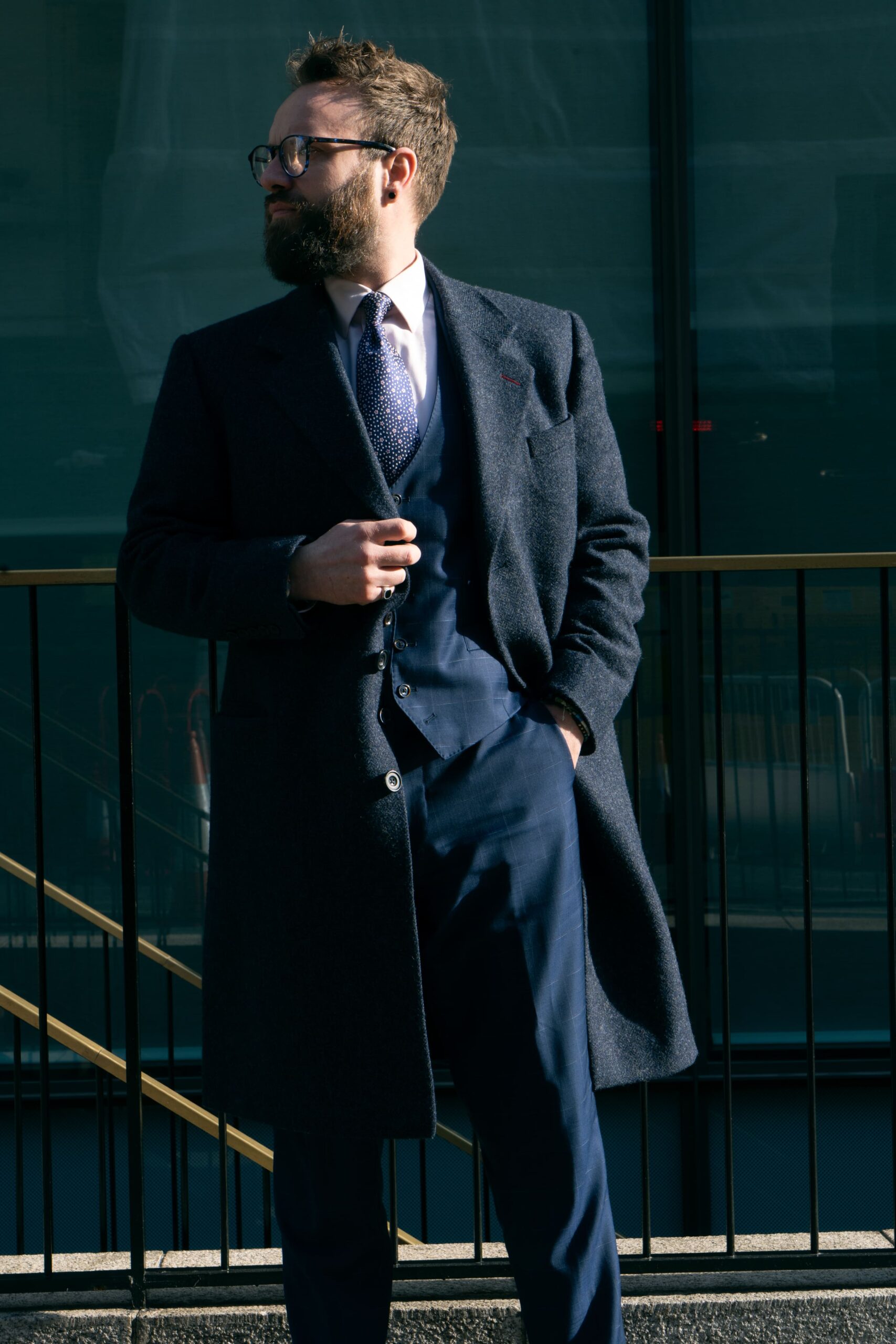 Dark navy overcoat worn over a suit and tie, sample image