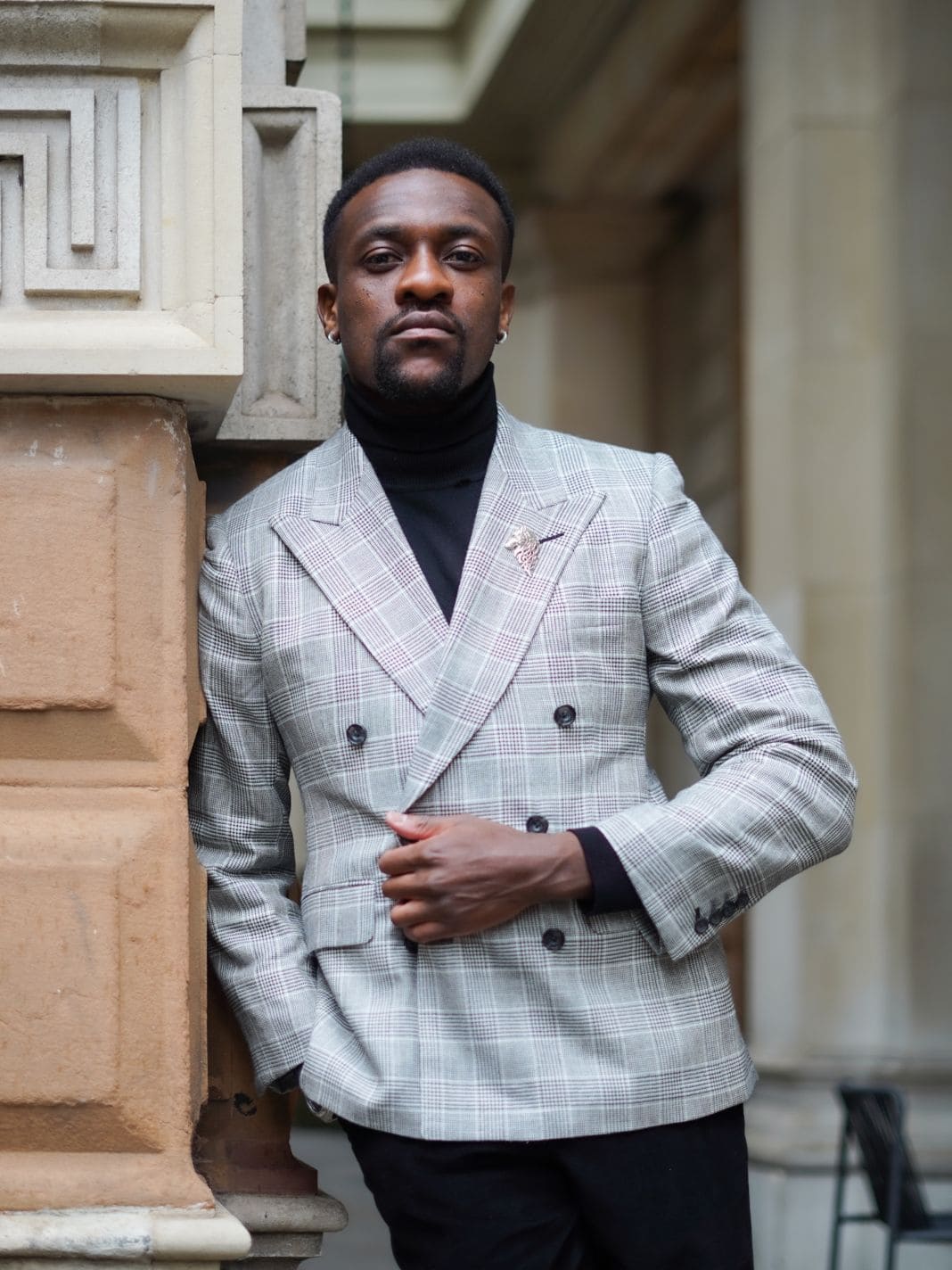 Light grey double-breasted blazer worn with a black turtleneck