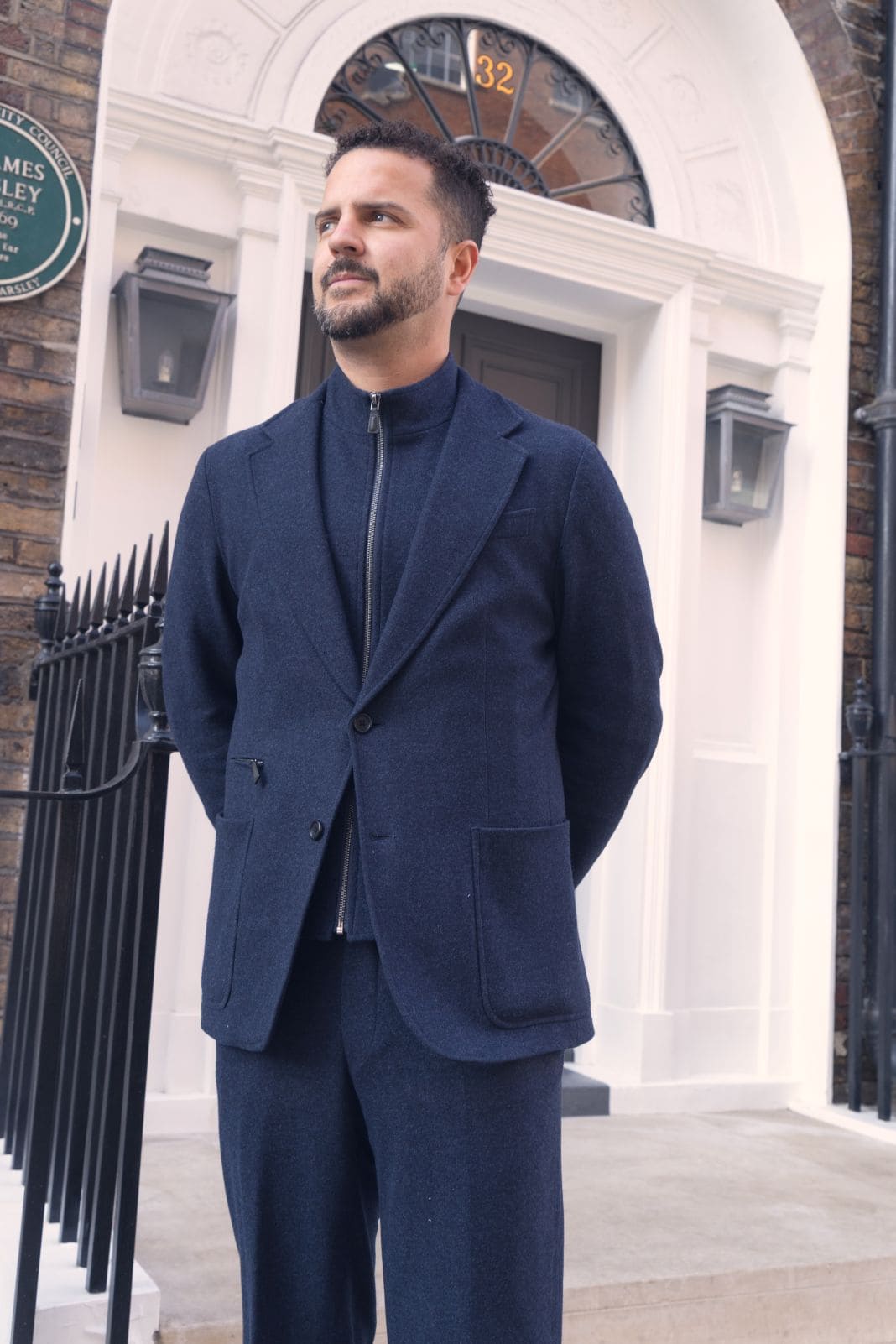 Navy tailored jacket worn with a black turtleneck