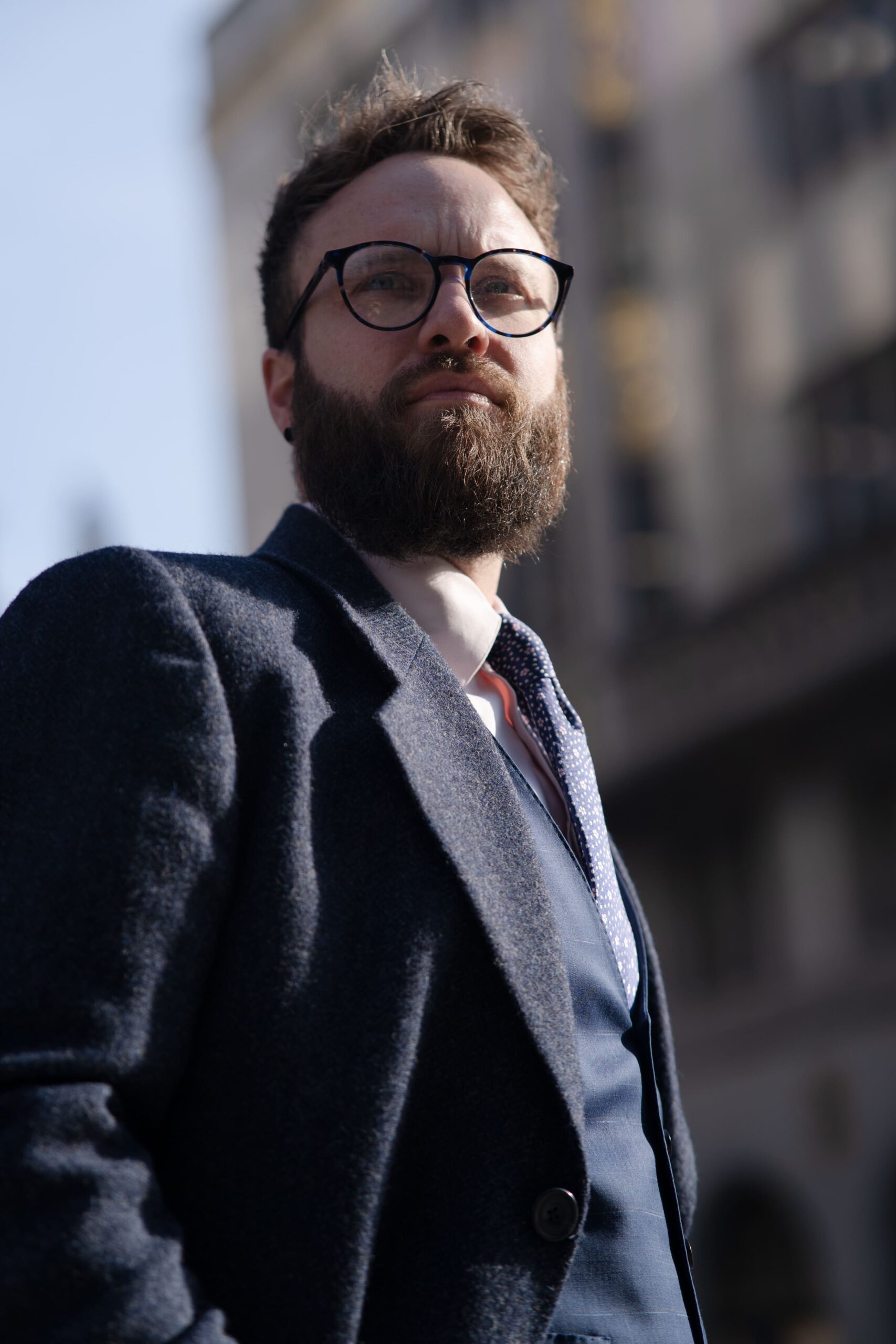 Navy tailored suit worn with a tie, sample image