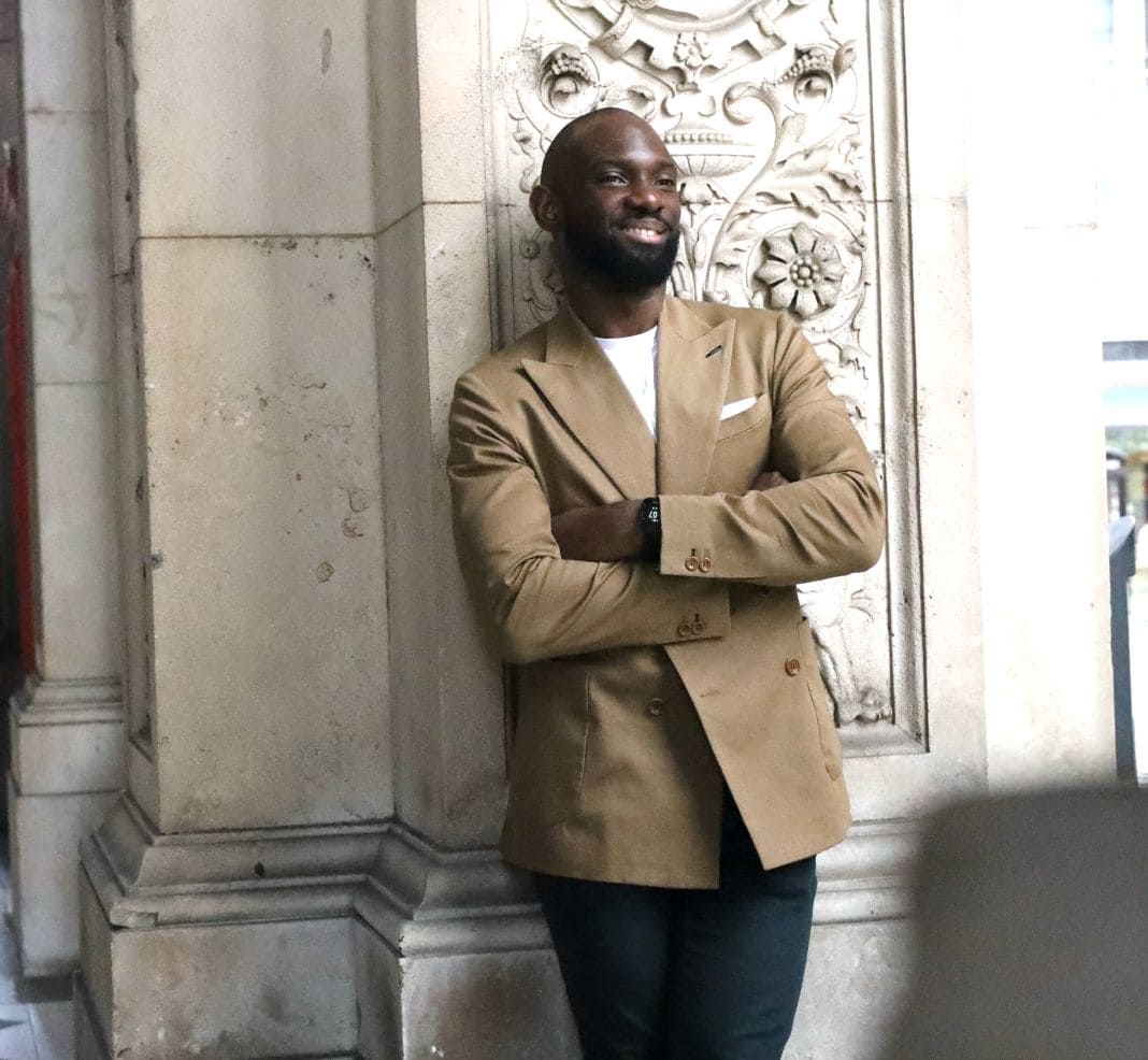Tan tailored blazer worn with a dark turtleneck