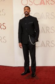a photo of a man wearing all black tailored outfit at the oscars