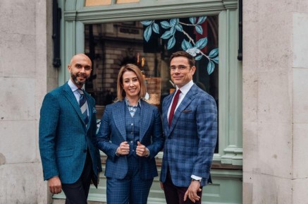 a photo of three london tailors posing for a photo