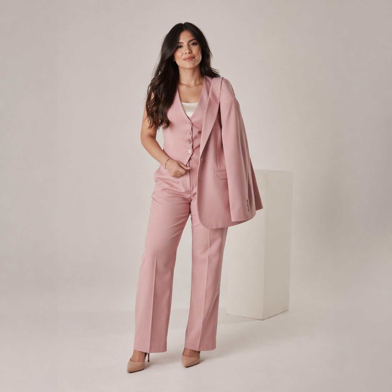 Blush pink tailored blazer worn with wide-leg trousers
