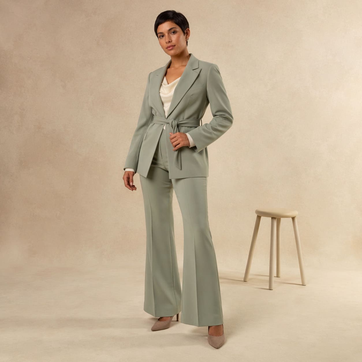 Sage green tailored blazer worn with wide leg trousers