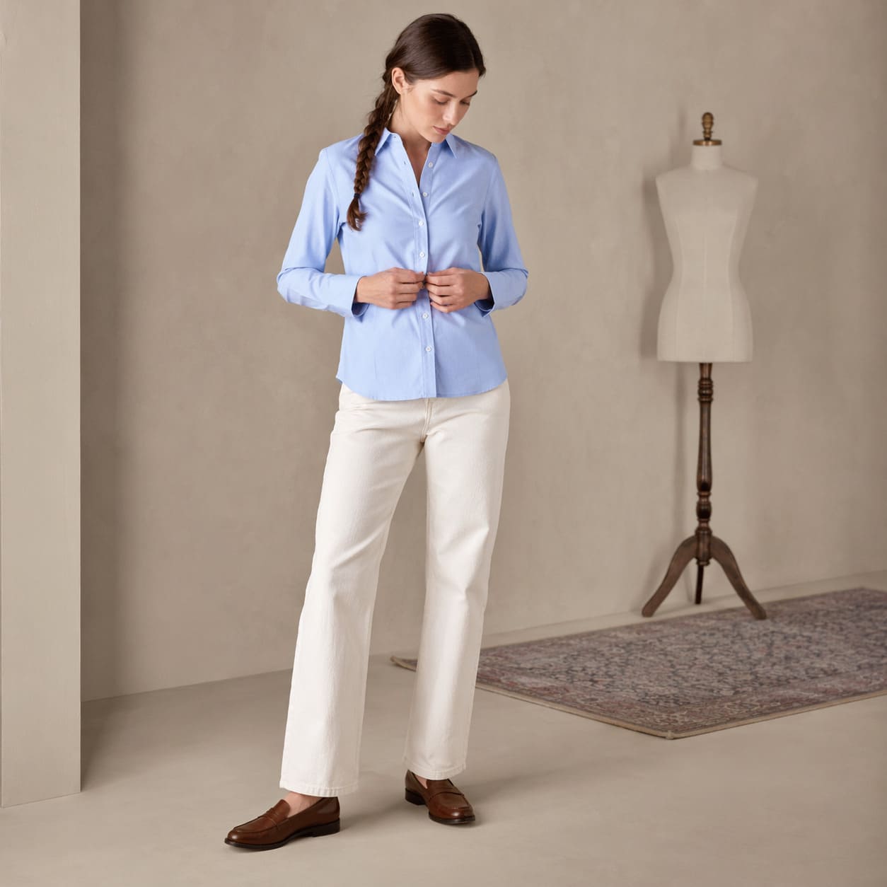 Light blue button-up shirt worn with cream trousers