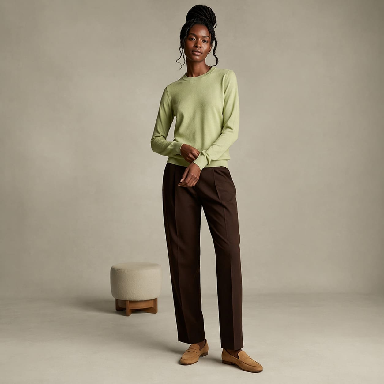 Light green sweater worn with brown slim-fit trousers, sample image