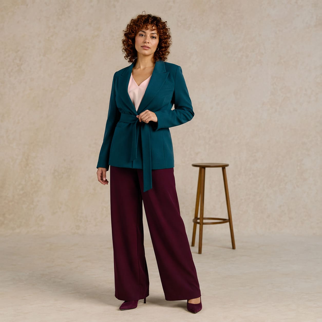 Teal blazer worn with burgundy wide-leg trousers