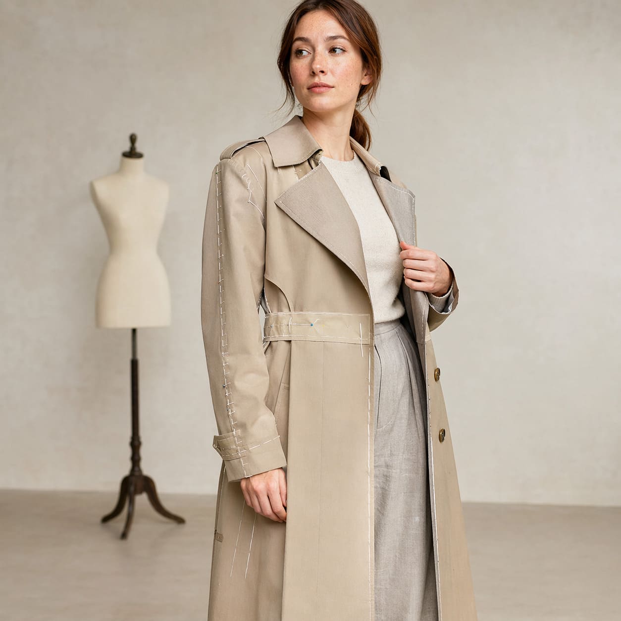 Beige trench coat with a classic double-breasted front, sample image
