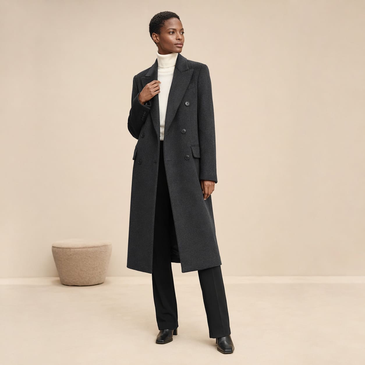Charcoal longline coat worn with tailored black trousers, sample image